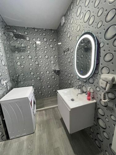 a bathroom with a sink and a mirror at Panorama Sea View Apartments in Vlorë