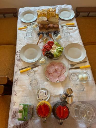 a table with plates and food on top of it at Qyteza Guest House & Camping in Shkodër