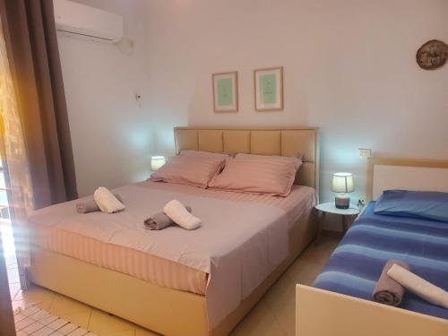 a bedroom with a bed with two pillows on it at Apartament 1+1 Plazh Durrës in Durrës