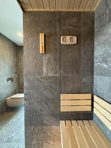 a bathroom with a shower with a bench in it at Wille w Lake Hill Karkonosze Resort & SPA in Sosnówka