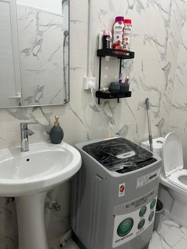 a bathroom with a sink and a stove at 8 Luxury Studio in Abu Dhabi