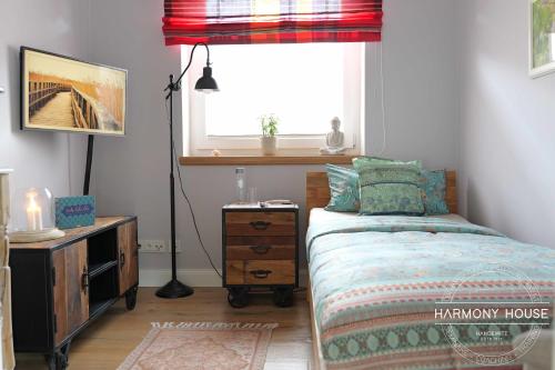 a bedroom with a bed with a dresser and a window at Harmony House in Handewitt