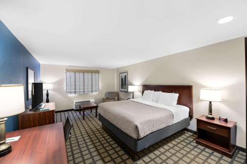 a hotel room with a bed and a desk at Quality Inn & Suites Big Spring in Big Spring