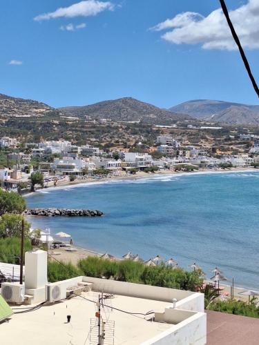 a view of a beach with buildings and the ocean at Marena 2 in Makry Gialos