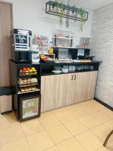 a kitchen with a counter with an open refrigerator at HOTEL MAREA in Poio