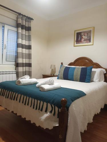 a bedroom with a bed with towels on it at Casas do Castelo in Aldeia da Serra
