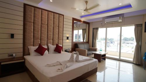 a bedroom with a bed and a living room at Royal Gitanjali Resorts and Spa in Mandarmoni