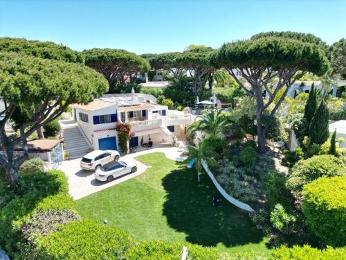 an aerial view of a house with a car parked in the yard at Royal Course Villa, Vale do Lobo in Vale do Lobo