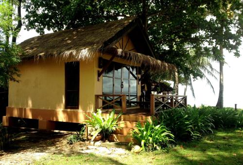 a small house with a thatched roof at Nautilus Right on the Beach - Adult Only - SHA Extra Plus in Ko Lanta