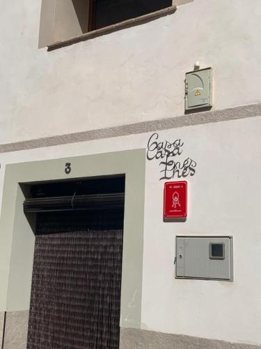 a building with a door and a sign on it at Casa Inés in Penáguila