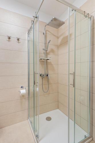 a shower with a glass door in a bathroom at Bella Vista in Cres