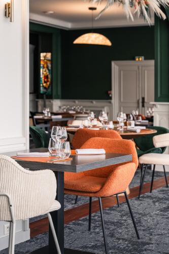 a dining room with tables and chairs in a restaurant at Le Goyen in Audierne