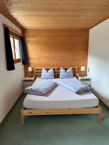 a bedroom with a bed with two pillows on it at Ferienwohnung Crameri in Klosters