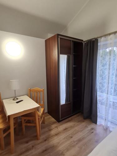 a room with a table and a table and a window at Pokoje Gościnne Na Szlaku in Krościenko