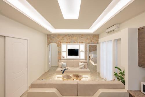 a living room with a skylight in the ceiling at Loukas & Emma Houses in Perissa