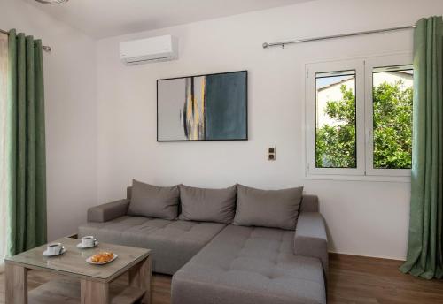 a living room with a couch and a table at 7thHeaven Luxury aprts in Chania Town
