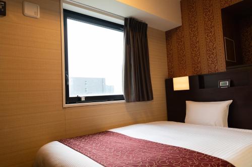 Postel nebo postele na pokoji v ubytování Hotel. Links Namba