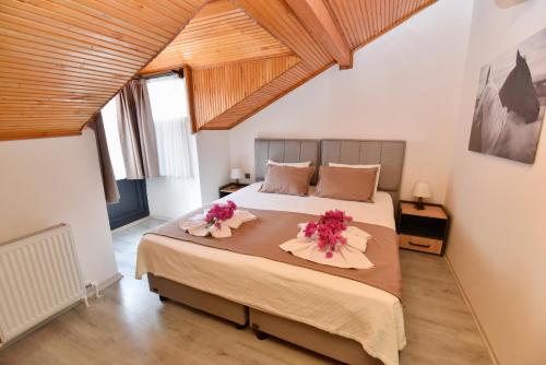 a bedroom with a large bed with flowers on it at Mykonut Boutique Suites in Fethiye