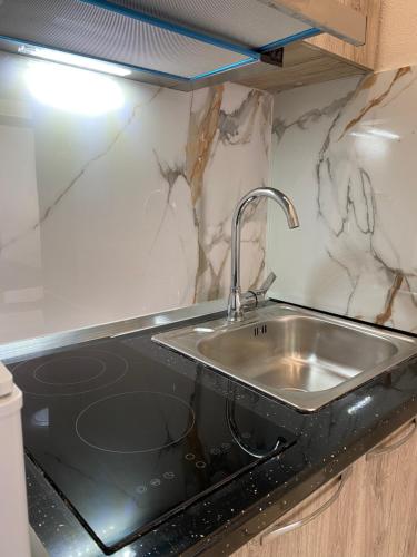 a kitchen with a sink and a counter top at Troy ApartHotel Durres in Durrës