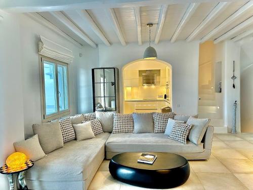 a living room with a couch and a table at Grace Villa Mykonos in Mikonos