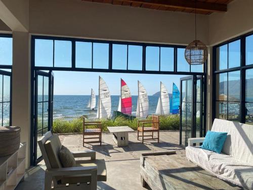 a living room with sail boats in the water at Joma Adventure Lodge in Senga