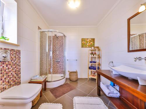 a bathroom with a sink and a toilet and a tub at VILLA SCARLETT in Kaş