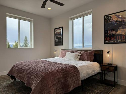 Thayne的住宿－Pickleball Paradise at Star Valley Ranch!，一间卧室设有一张大床和两个窗户。