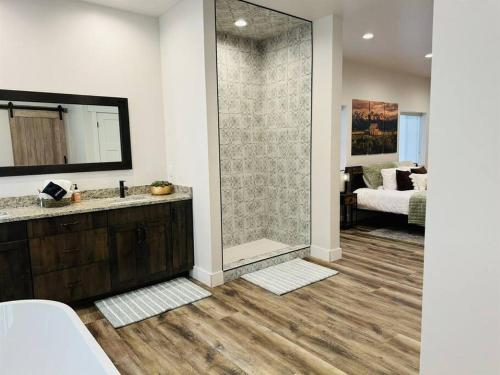a bathroom with a shower and a sink with a mirror at Pickleball Paradise at Star Valley Ranch! in Thayne