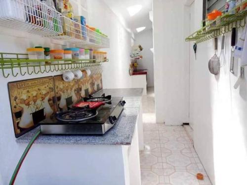 a kitchen with a stove top in a room at White House Villa in Dumaguete