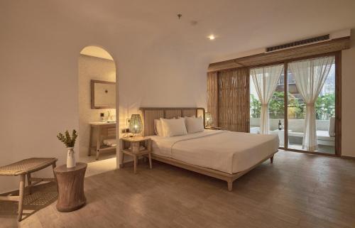 a bedroom with a bed and a large window at Sky Gem Hotel Sora in Ho Chi Minh City