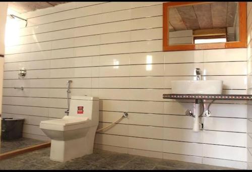 a bathroom with a toilet and a sink at Royal Rangers Desert Safari Camp in Jaisalmer