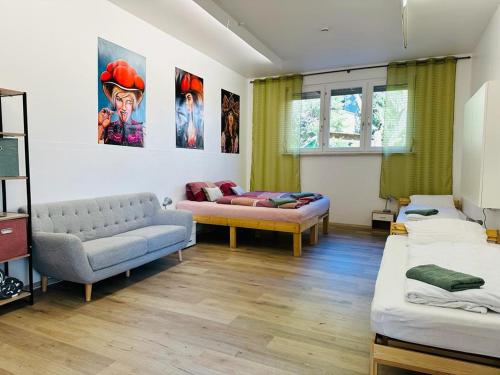 a living room with two beds and a couch at Gemütliche Unterkunft in Baden-Baden direkt am Schwarzwald in Baden-Baden