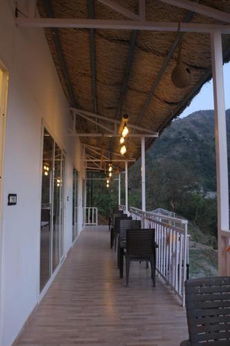 a porch with a row of chairs on a building at AVTARA RESORT RISHIKESH in Rishīkesh