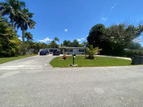 a house with a parking meter on the side of a road at Private Retreat in Lake Worth