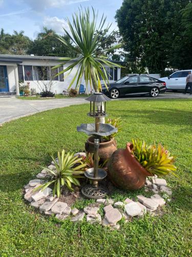 a fountain in the grass in a yard at Private Retreat in Lake Worth