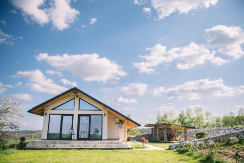 a small house with a large window at Casa moderna in Sinteu - intersectia intre modern si linistea naturii in Huta Voivozi