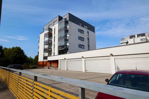 a building with a car parked in a parking lot at Cozy flat with side Baltic Sea view in Pärnu