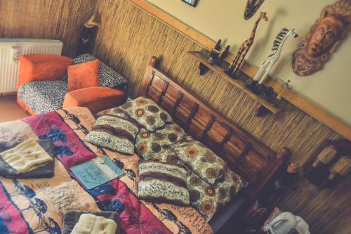 a bedroom with a bed and a guitar on the wall at Édes Otthon Vendégház in Nagybörzsöny