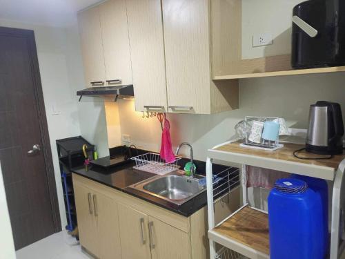 a small kitchen with a sink and a counter at Brenthill Condo Quartz Unit in Baguio