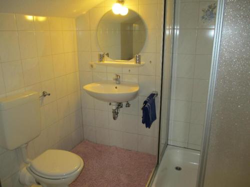 a bathroom with a toilet and a sink and a shower at Apartment für zwei Erwachsene und ein Kind mit Balkon - b57048 in Bad Füssing