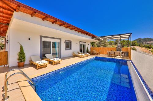a villa with a swimming pool and a patio at Rhapsody Hotel Kas in Kaş