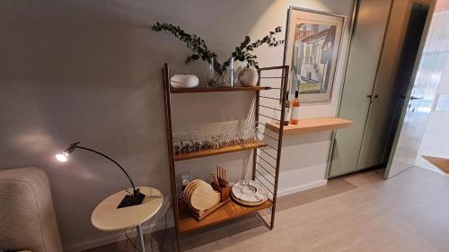 a room with a shelf with a lamp and a table at Calming Mountain View Apt with Balcony & Free Parking near Kakopetria in Nicosia