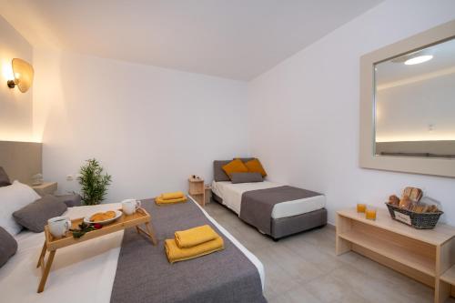 a living room with a bed and a couch at Elenas Village House - Love apartment with Pool and Terrace in Alikianós