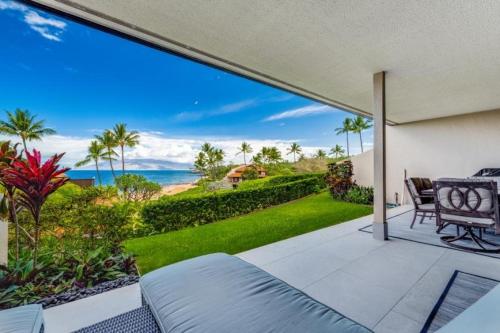 an open patio with a view of the ocean at MAKENA SURF #C102 condo in Wailea