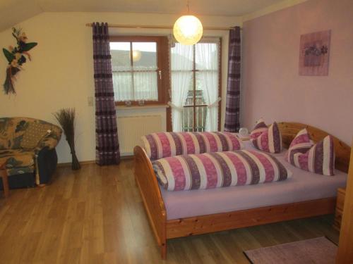 a bedroom with a bed with pillows on it at Apartment für zwei Erwachsene und ein Kind mit Balkon in Bad Füssing