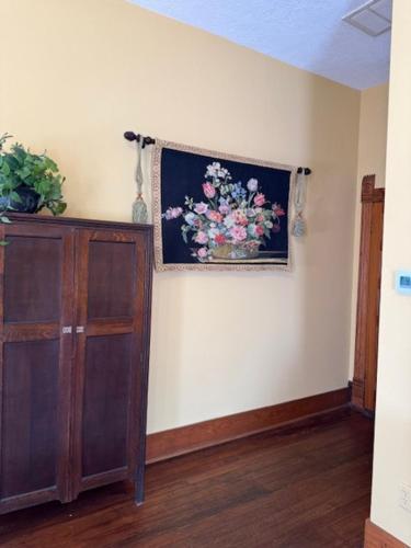 a room with a painting of flowers on the wall at Woodbine Inn and Restaurant in Madisonville