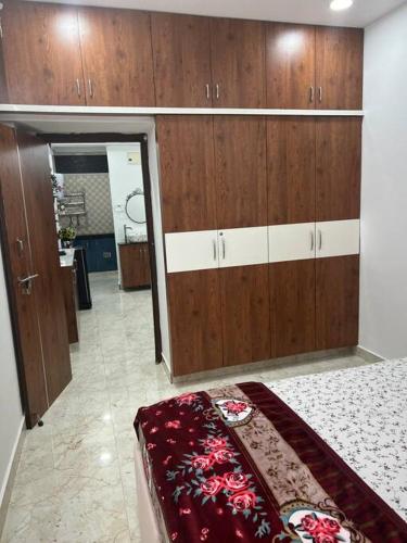 a room with wooden cabinets and a bed in it at Atlas Homes 1BHK HomeStays in Hyderabad