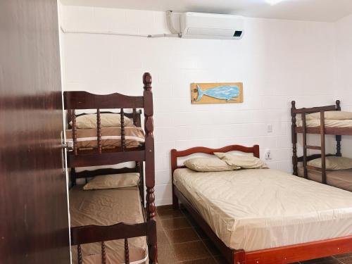 a room with two bunk beds in a room at Casinhas Terõ - in São Sebastião