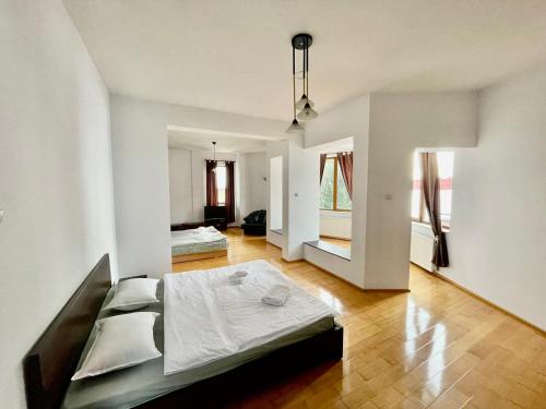a large white room with a bed in it at Vila Wiese Poiana Brasov in Braşov
