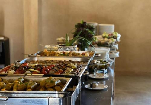 a buffet line with many different types of food at The quiet desert in Wadi Rum